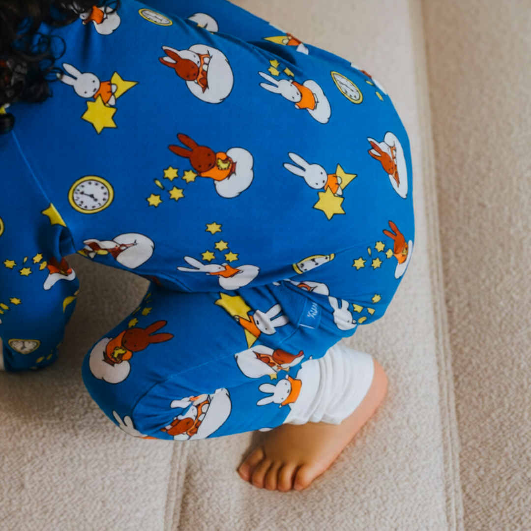 Baby wearing the ZIPSTER x Miffy Starry Sleep bamboo babygrow